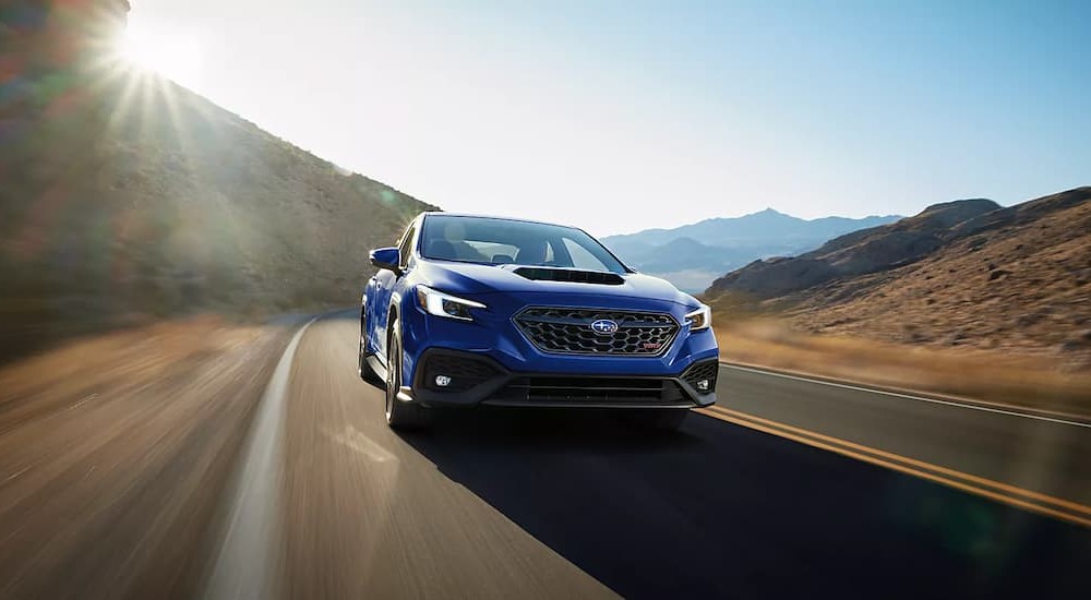 A blue 2026 Subaru WRX driving on a highway.