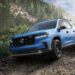 A blue 2025 Honda Pilot TrailSport off-roading down a rocky trail.