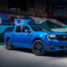 A blue 2025 Ford Maverick Lobo parked in front of modern street art.