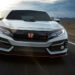 A white 2021 Honda Civic Type-R is shown driving to a Honda dealer.