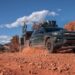 A dark green 2024 Ford Explorer Timberline off-roading through a desert.