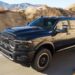 A black 2024 Ram 2500 HD Rebel driving to view used trucks for sale.