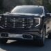 Black 2025 GMC Sierra 1500 Denali Ultimate driving down the road