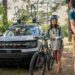 A white 2023 Ford Bronco Sport parked near two people with bikes.