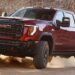 A red 2025 GMC Sierra 2500 AT4X off-roading