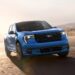 A blue 2025 Ford Maverick Lobo driving near racing cones.