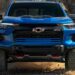 A blue 2025 Chevy Colorado ZR2 off-roading on a trail