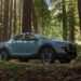 A blue 2026 Hyundai Santa Cruz for sale parked in a forest.