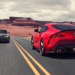 Red 2026 Toyota Supra GR driving past a black 2026 Toyota Supra GR