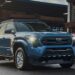 A blue 2026 Toyota Tacoma parked in a lumber yard.