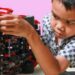A child is building a toy car.