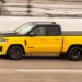A yellow 2027 Ram Rumble Bee is driving on a track.
